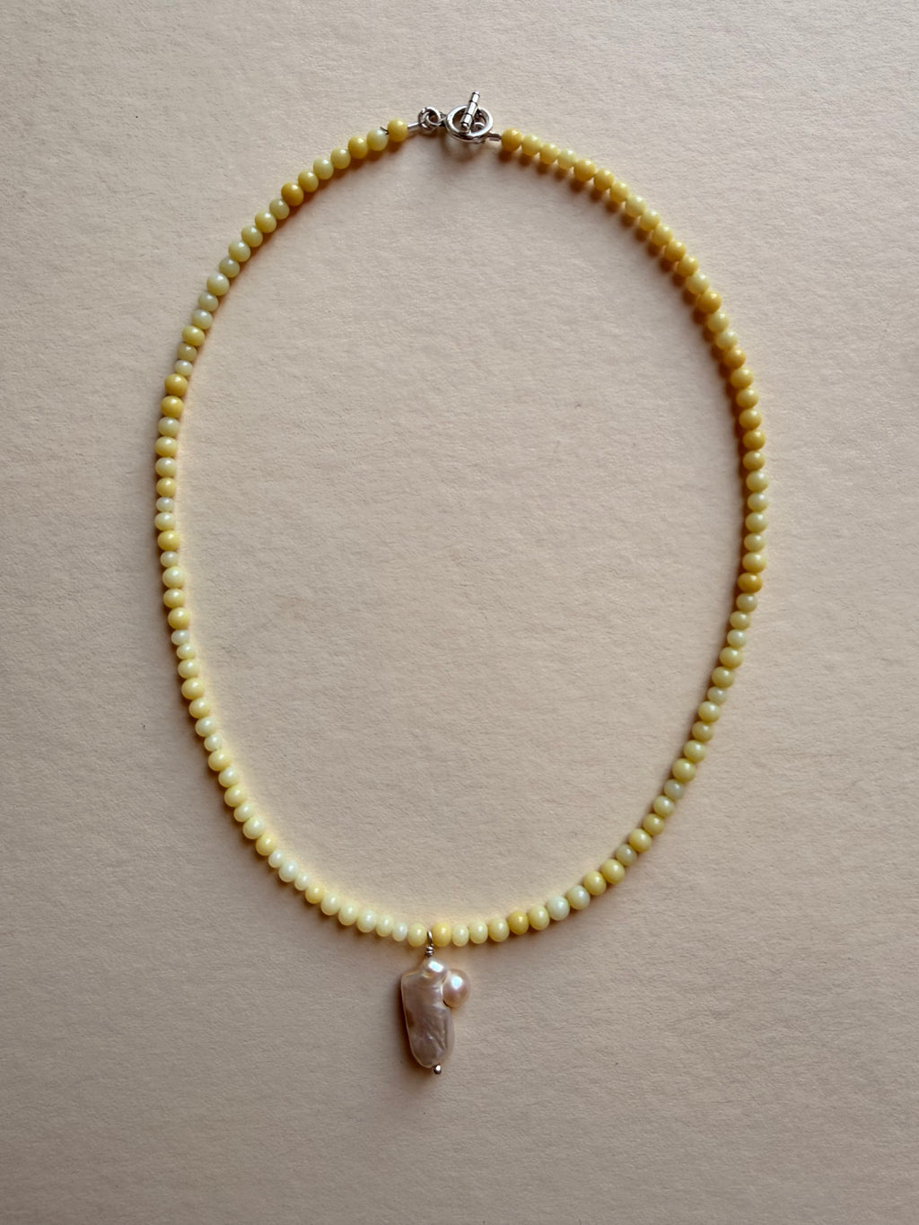 butter with pearl pendant