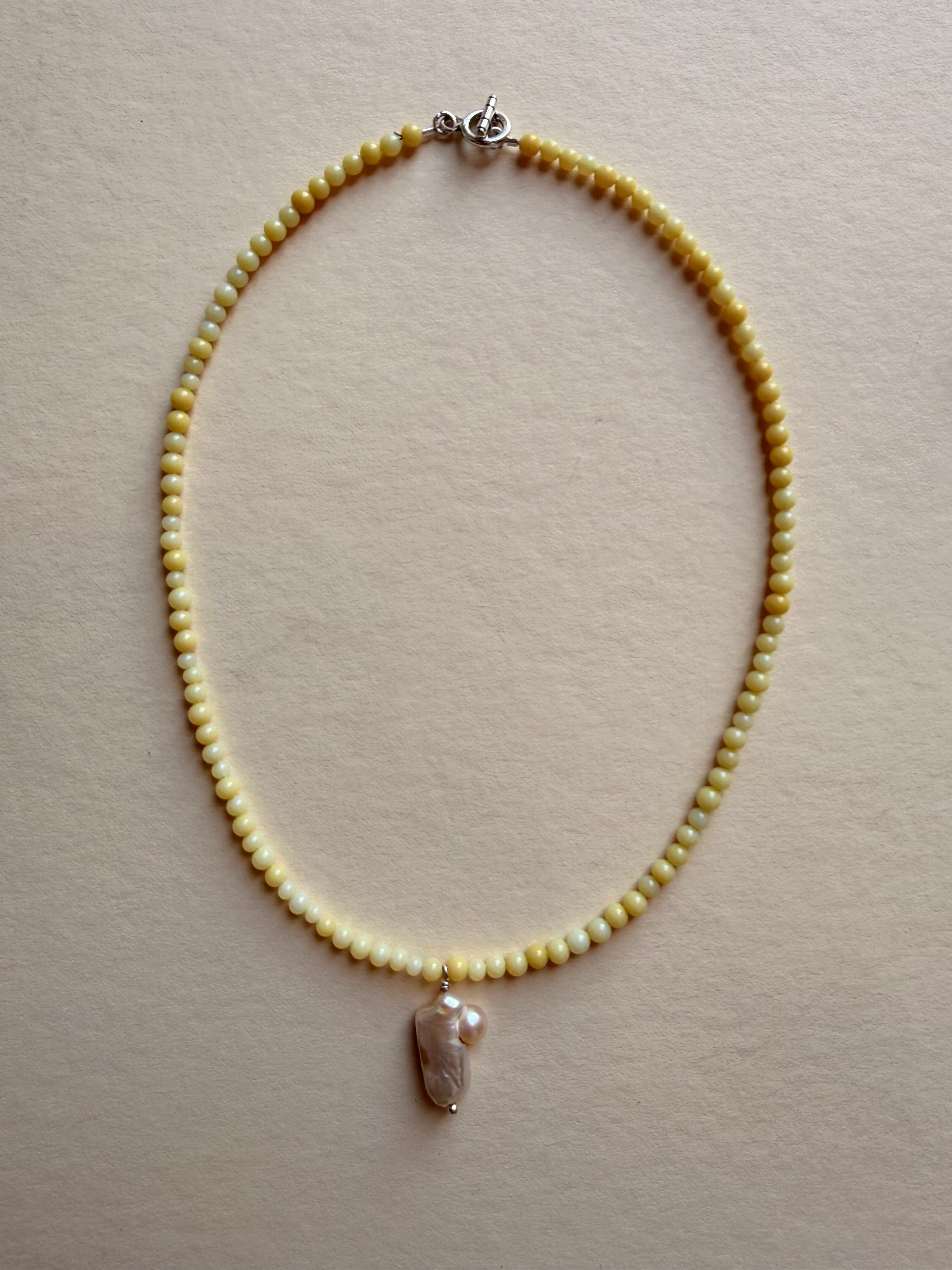 butter with pearl pendant