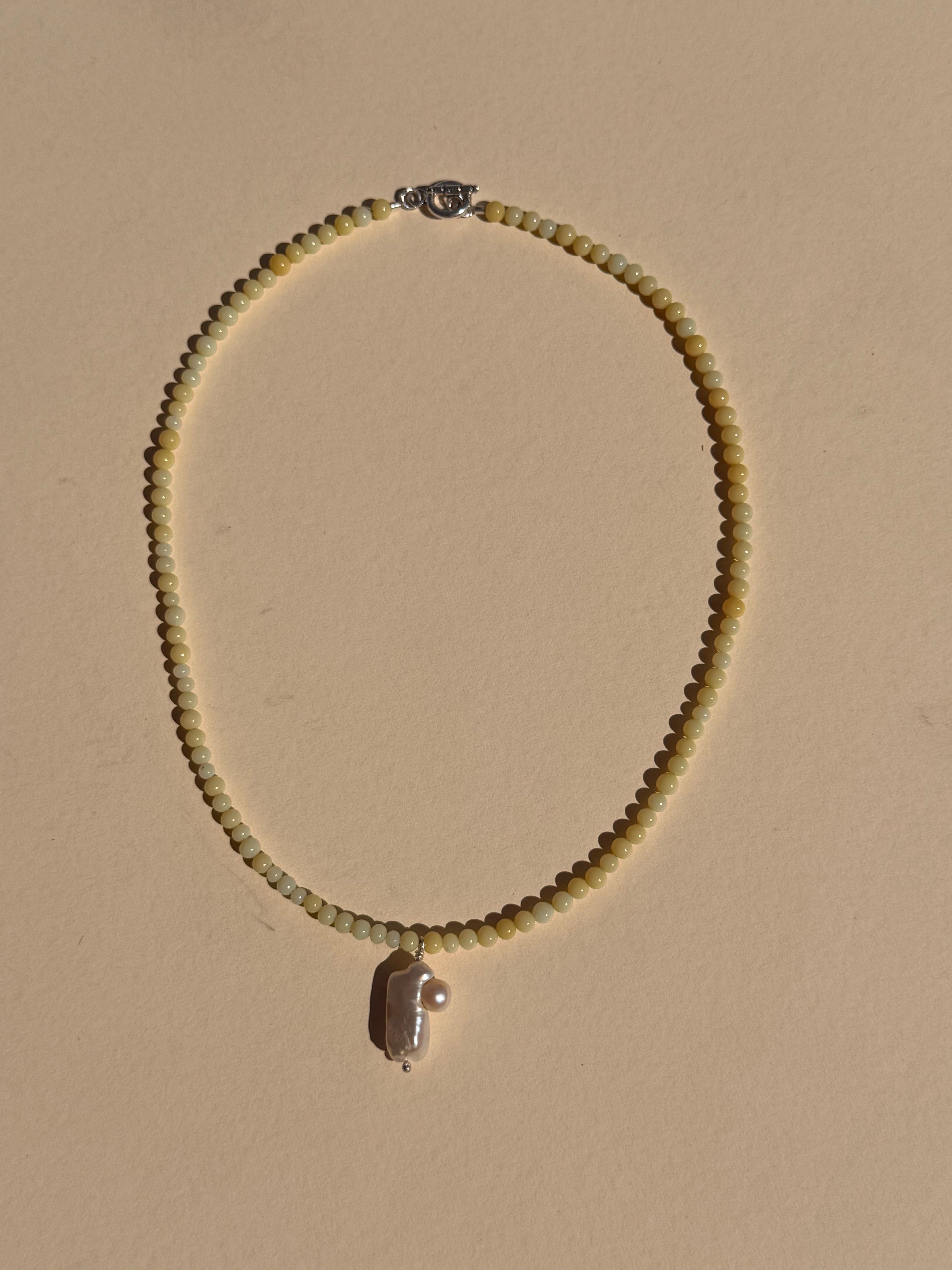 butter with pearl pendant